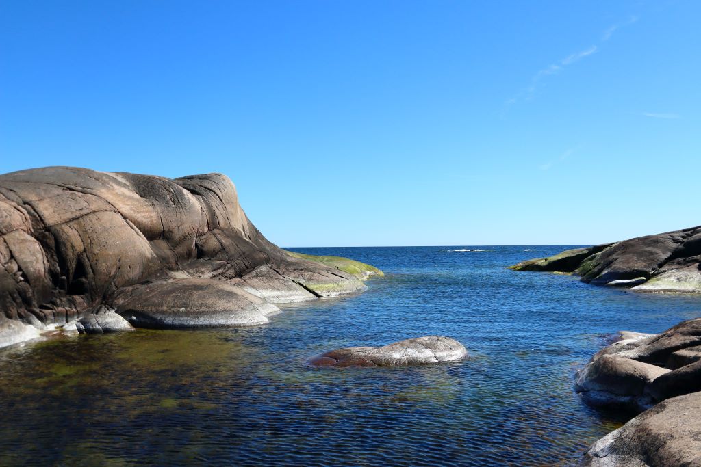 View of a small bay in the Baltic sea surrounded by granite cliffs